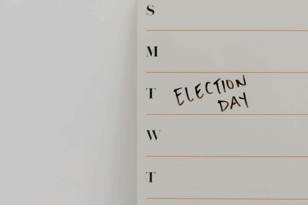 A vertical list of the first letters of each day. Next to the T for Tuesday are the words Election Day